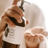 8oz Sea Salt Surf Body Lotion being dispensed into a hand. 